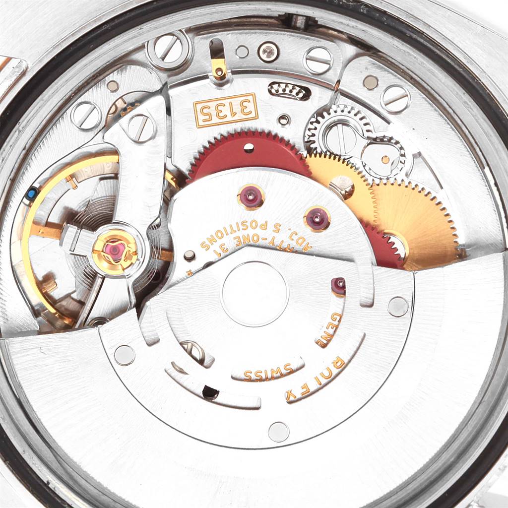 This image shows the internal mechanism of a Rolex Datejust 116233 Men's Stainless Steel Black Dial 116233 Men's Stainless Steel Black Dial watch from a close-up, angled view of its movement components.