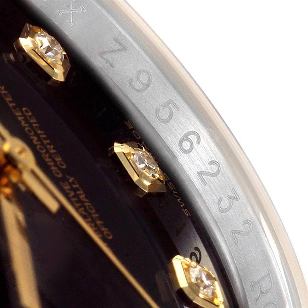 This close-up of a Rolex Datejust 116233 Men's Stainless Steel Black Dial 116233 Men's Stainless Steel Black Dial shows part of the dial, bezel, diamond markers, and serial number engraving.