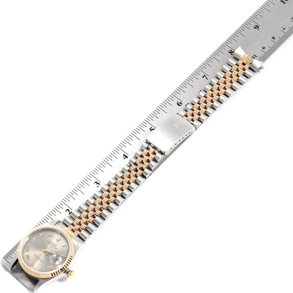 This image shows a Rolex Datejust 16233 Men's Steel and Gold (two tone) Grey Dial 16233 Men's Steel and Gold (two tone) Grey Dial watch from a top-down angle, featuring the dial, bracelet, and clasp next to a ruler.