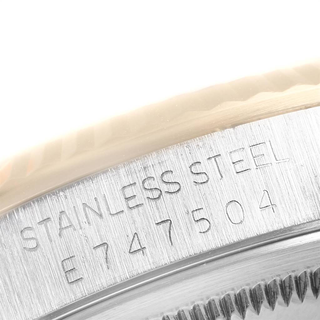 This close-up image shows the stainless steel case and serial number of the Rolex Datejust 16233 Men's Steel and Gold (two tone) Silver Dial 16233 Men's Steel and Gold (two tone) Silver Dial watch.