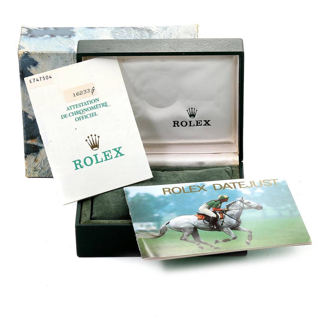 The image shows the packaging and documentation for a Rolex Datejust 16233 Men's Steel and Gold (two tone) Silver Dial 16233 Men's Steel and Gold (two tone) Silver Dial watch, including the box, a booklet, and a certificate.