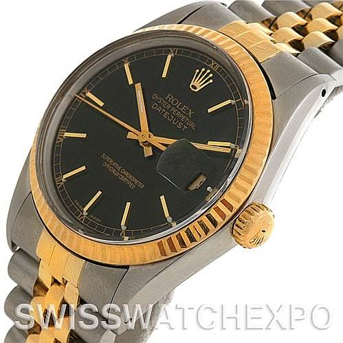 The image shows a close-up angled view of a Rolex Datejust 16013 Men's Stainless Steel Black Dial 16013 Men's Stainless Steel Black Dial watch, highlighting its black dial, gold fluted bezel, and two-tone metal bracelet.