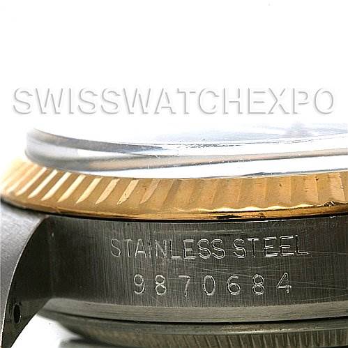 This image shows a side view of the Rolex Datejust 16013 Men's Stainless Steel Black Dial 16013 Men's Stainless Steel Black Dial watch, highlighting the fluted bezel and the stainless steel case with engraved serial number.