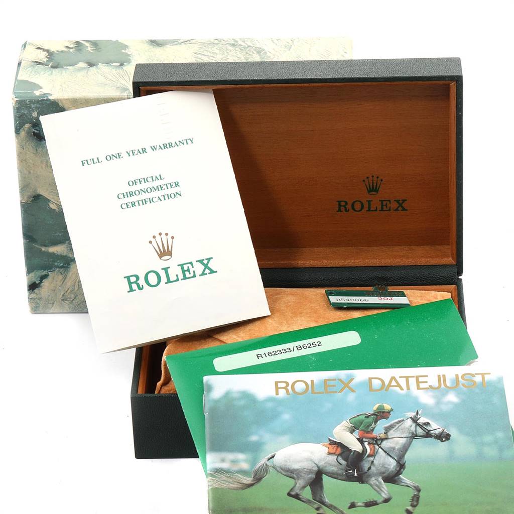 The image shows an open Rolex Datejust 16233 Men
s Steel and Gold (two tone) Blue Dial 16233 Men
s Steel and Gold (two tone) Blue Dial watch box with warranty papers and the official chronometer certification.