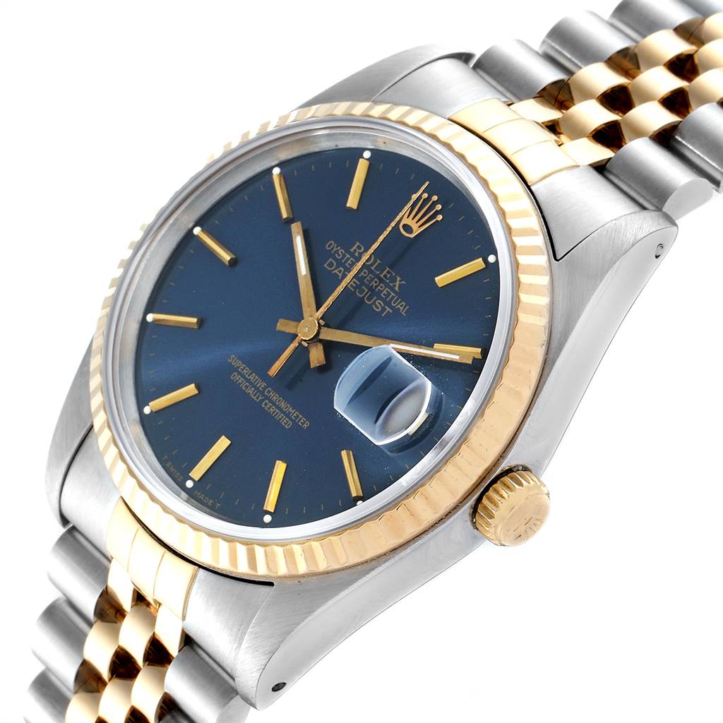 The Rolex Datejust 16233 Men
s Steel and Gold (two tone) Blue Dial 16233 Men
s Steel and Gold (two tone) Blue Dial watch is shown at an angle displaying the face, crown, fluted bezel, and Jubilee bracelet.