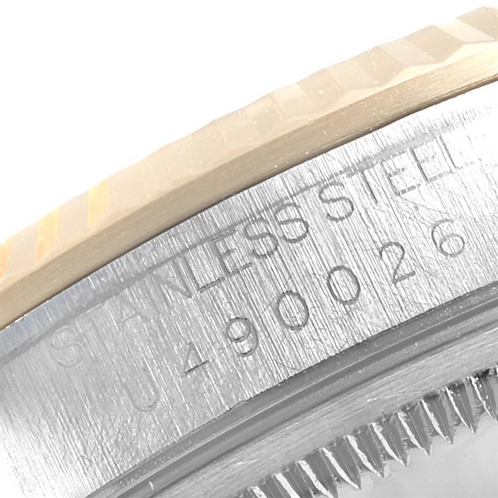 The image shows a close-up of the serial number and part of the bezel of a Rolex Datejust 16233 Men's Steel and Gold (two tone) Beige Dial 16233 Men's Steel and Gold (two tone) Beige Dial watch.