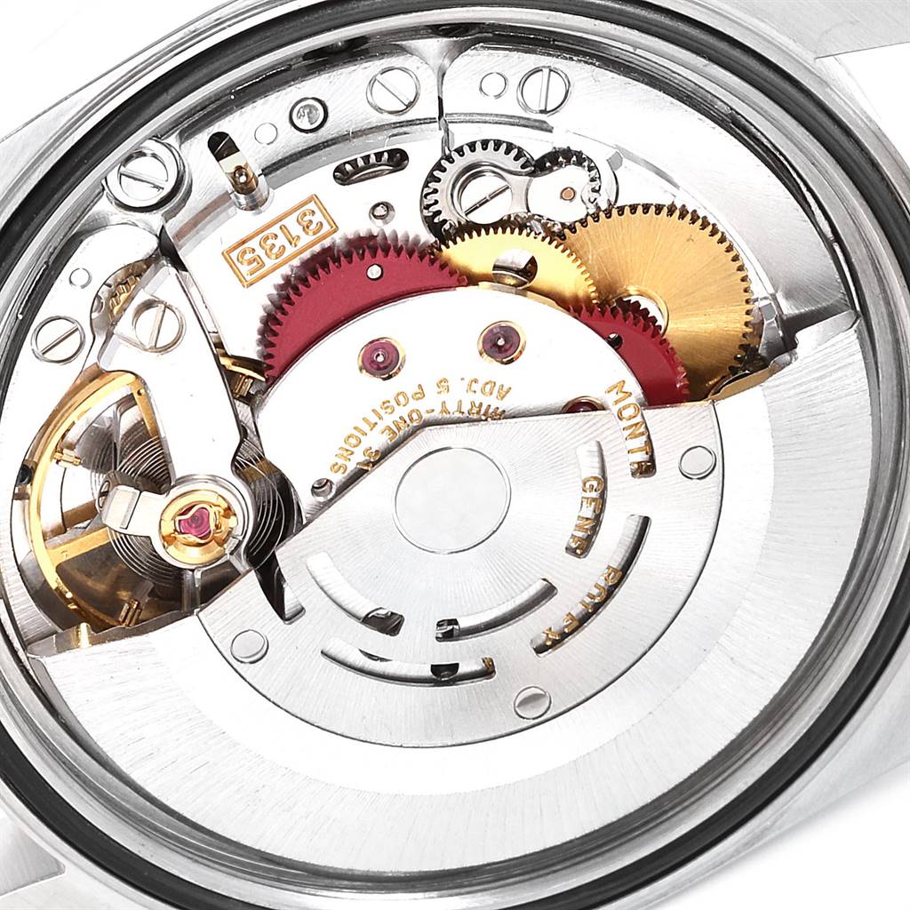 This image shows the internal mechanical movement of a Rolex Datejust 16233 Men's Steel and Gold (two tone) Beige Dial 16233 Men's Steel and Gold (two tone) Beige Dial watch, featuring gears, cogs, and other components.