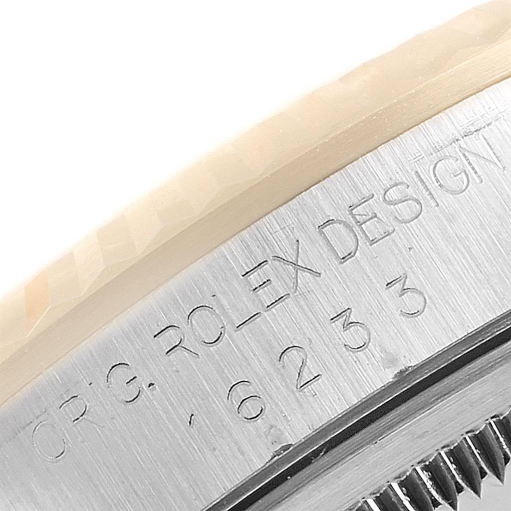 This close-up image shows the engraved side of the bezel of a Rolex Datejust 16233 Men's Steel and Gold (two tone) Beige Dial 16233 Men's Steel and Gold (two tone) Beige Dial watch.