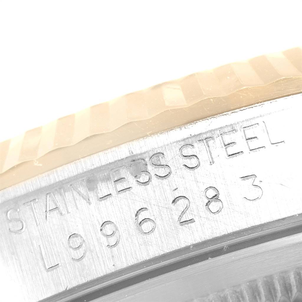 This image shows a close-up of the serial number and "Stainless Steel" engraving on the side of a Rolex Datejust 16233 Men's Steel and Gold (two tone) Champagne Dial 16233 Men's Steel and Gold (two tone) Champagne Dial watch.