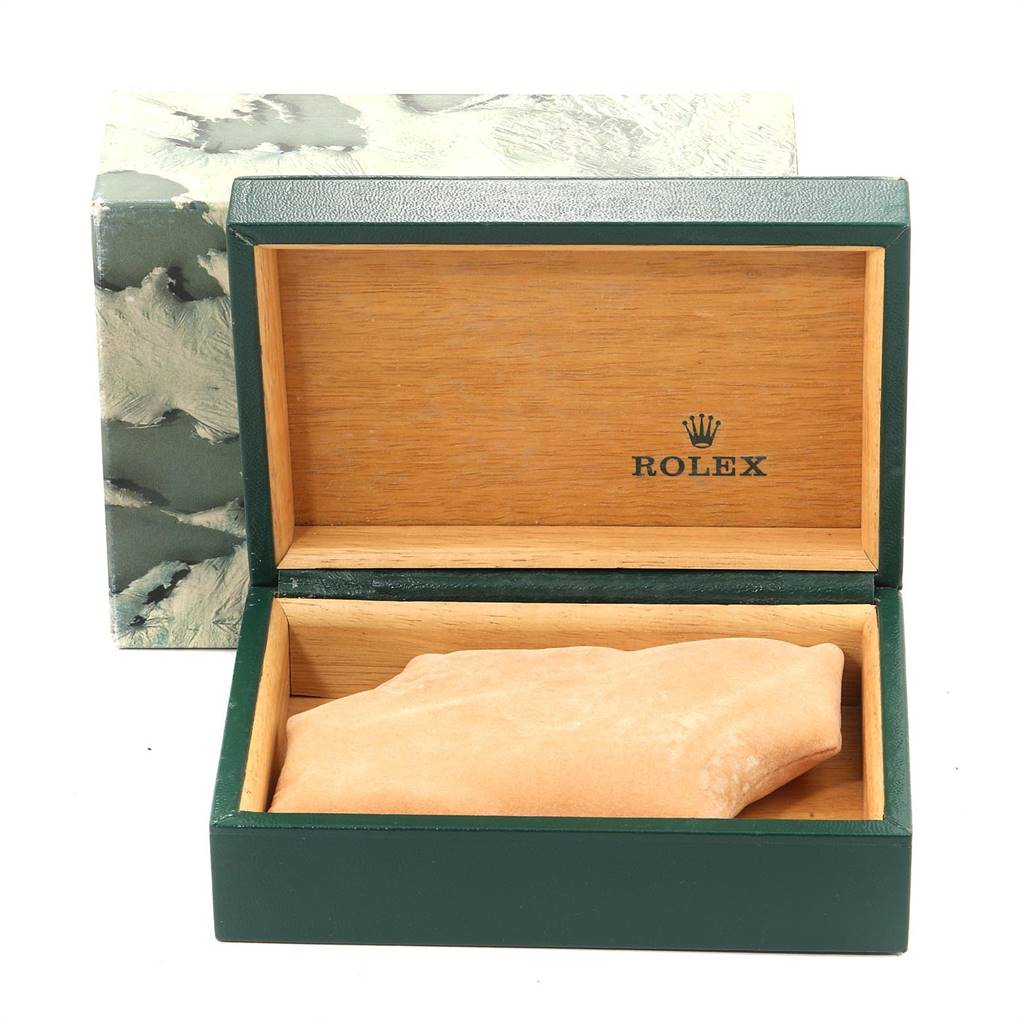 The image shows an open Rolex Datejust 16233 Men's Steel and Gold (two tone) Champagne Dial 16233 Men's Steel and Gold (two tone) Champagne Dial watch box with a green exterior, wooden interior, and a beige cushion inside.