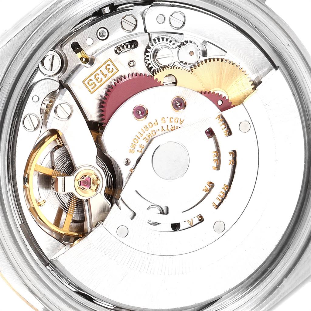 This is a close-up view of the internal mechanism of a Rolex Datejust 16233 Men's Steel and Gold (two tone) Grey Dial 16233 Men's Steel and Gold (two tone) Grey Dial watch, showcasing its intricate gears and components.