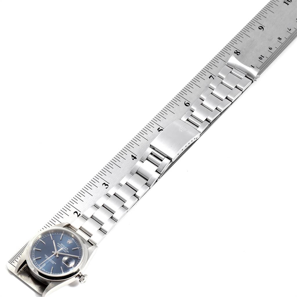 The image shows a Rolex Datejust 16200 Men's Stainless Steel Blue Dial 16200 Men's Stainless Steel Blue Dial watch placed alongside a ruler, highlighting its bracelet and clasp.