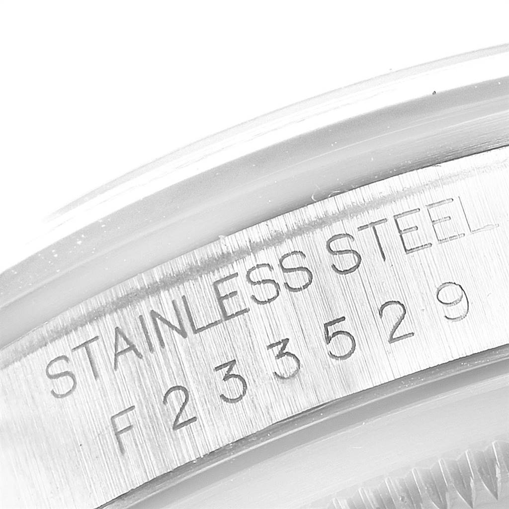 This image shows a close-up of the Rolex Datejust 16200 Men's Stainless Steel Blue Dial 16200 Men's Stainless Steel Blue Dial watch's stainless steel casing, featuring its engraved serial number.