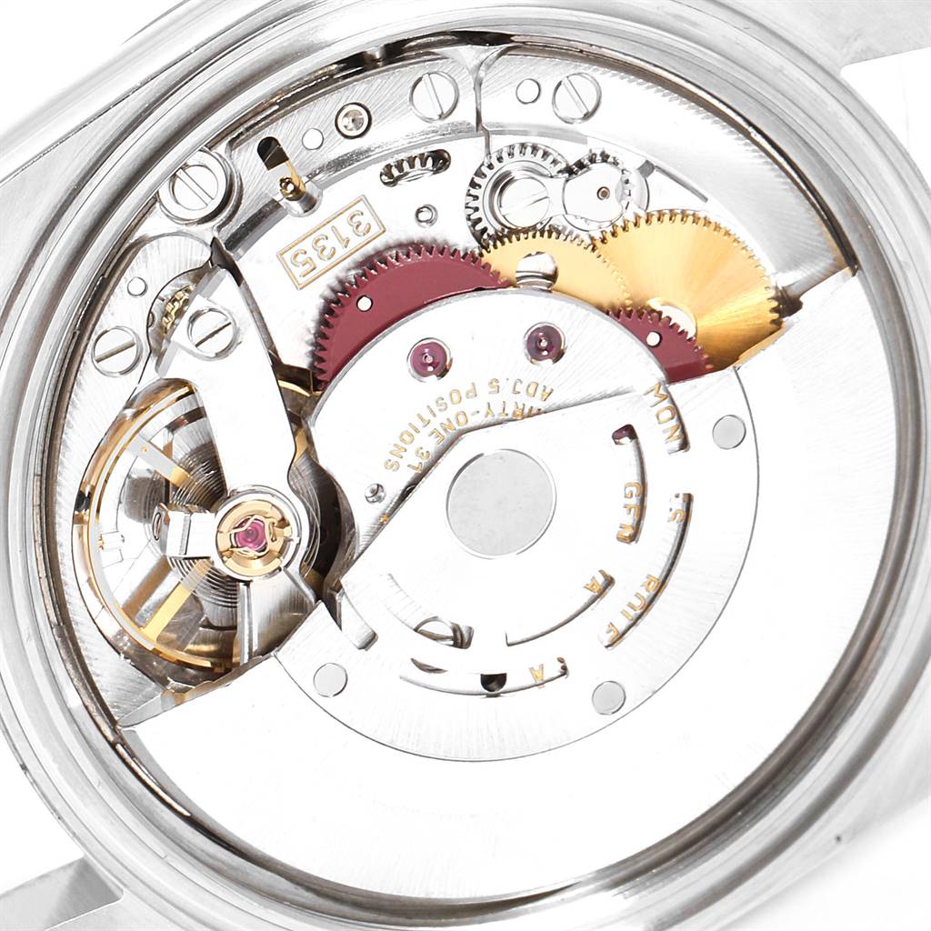 The image shows an inside view of the Rolex Datejust 16200 Men's Stainless Steel Blue Dial 16200 Men's Stainless Steel Blue Dial watch, focusing on its intricate movement mechanism and gears.