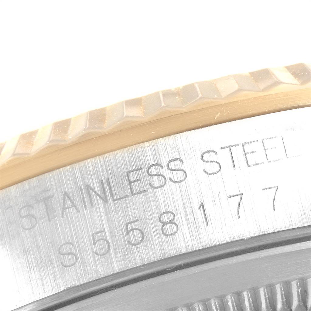 This close-up image shows the side of the bezel and case back of a Rolex Datejust 16233 Men
s Steel and Gold (two tone) Blue Dial 16233 Men
s Steel and Gold (two tone) Blue Dial watch, displaying "STAINLESS STEEL" and serial number.