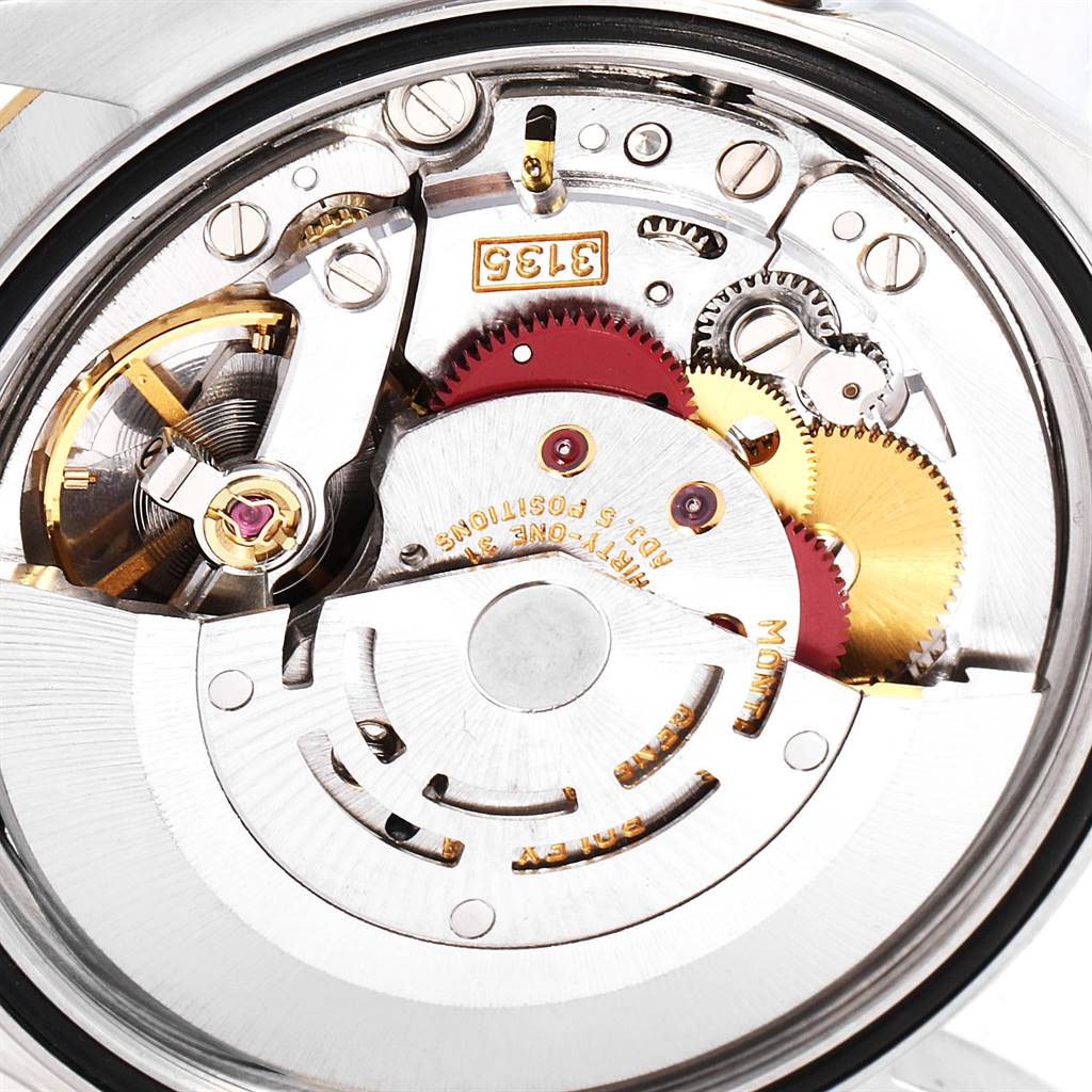 This image shows a close-up of the internal mechanism of a Rolex Datejust 16233 Men
s Steel and Gold (two tone) Blue Dial 16233 Men
s Steel and Gold (two tone) Blue Dial watch, highlighting gears and intricate components.