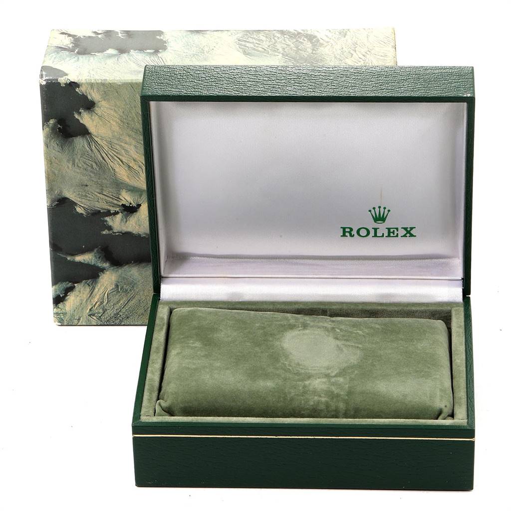 This image shows the open box of a Rolex Datejust 16233 Men
s Steel and Gold (two tone) Blue Dial 16233 Men
s Steel and Gold (two tone) Blue Dial watch, displaying the interior cushion and wooden box with the Rolex logo.