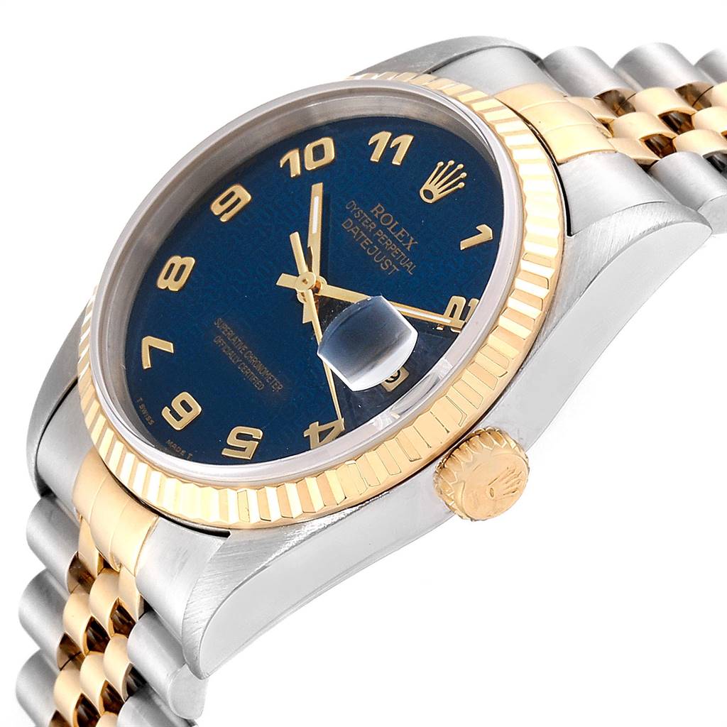 The image shows a side angle of a Rolex Datejust 16233 Men
s Steel and Gold (two tone) Blue Dial 16233 Men
s Steel and Gold (two tone) Blue Dial watch, highlighting the blue dial, gold bezel, crown, and two-tone bracelet.