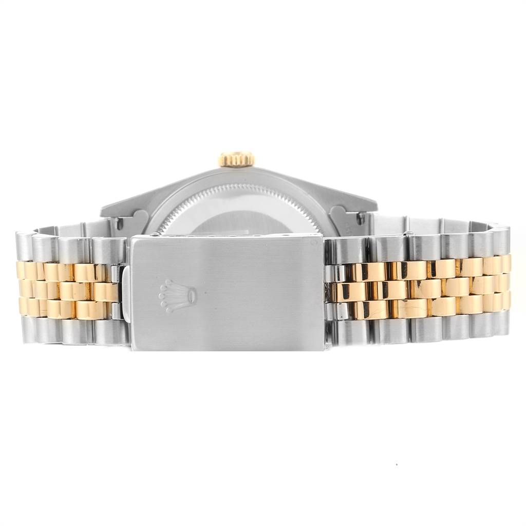 This image shows the backside of a Rolex Datejust 16233 Men's Steel and Gold (two tone) Blue Dial 16233 Men's Steel and Gold (two tone) Blue Dial watch focusing on the stainless steel and gold bracelet with a clasp.
