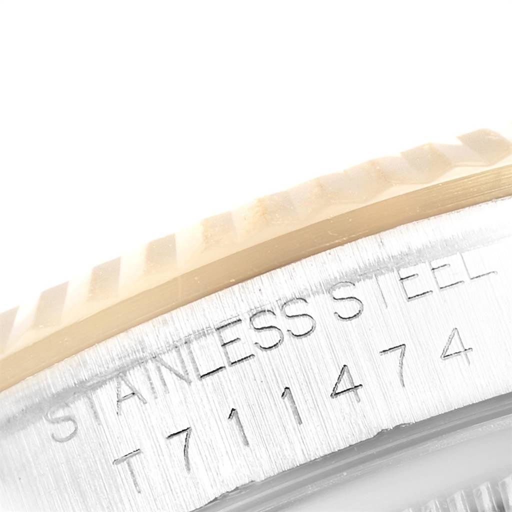 This close-up shows the edge of the bezel and part of the case back of the Rolex Datejust 16233 Men's Steel and Gold (two tone) Blue Dial 16233 Men's Steel and Gold (two tone) Blue Dial, highlighting the "Stainless Steel" engraving and serial number.