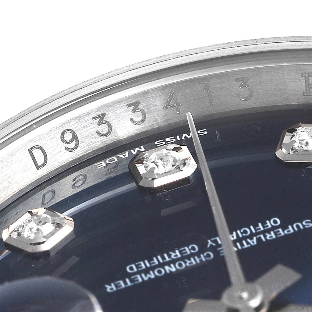The image shows a close-up of the dial and bezel, focusing on hour markers and part of the serial number, of a Rolex Datejust 116234 Men's Stainless Steel Blue Dial 116234 Men's Stainless Steel Blue Dial watch.