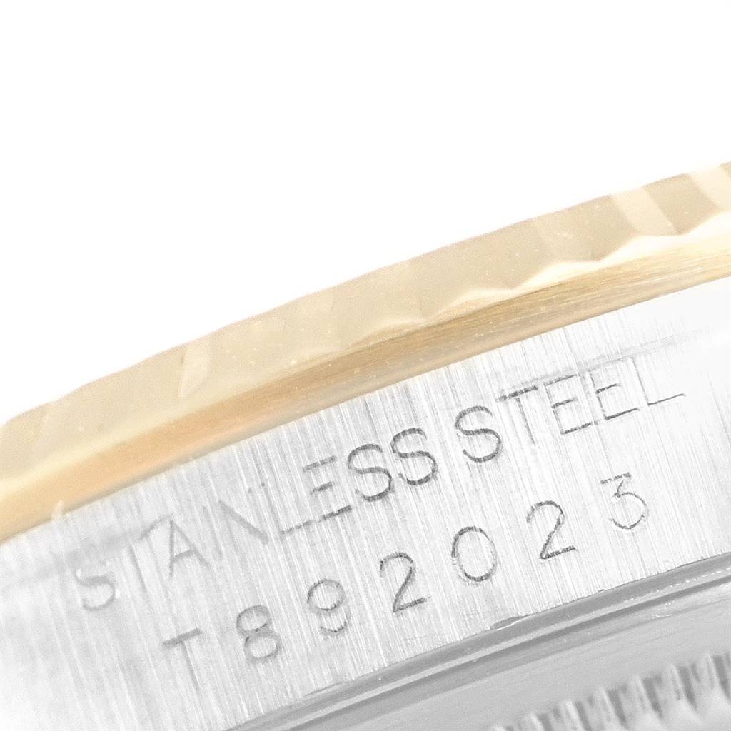 The image shows a close-up of the side of a Rolex Datejust 16233 Men's Steel and Gold (two tone) Grey Dial 16233 Men's Steel and Gold (two tone) Grey Dial watch, highlighting the stainless steel engraving and part of the fluted bezel.