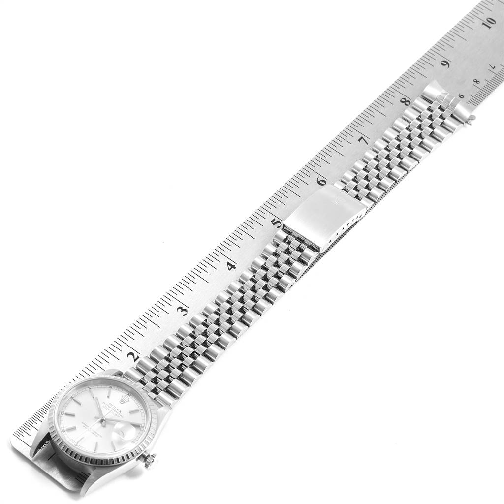 The image shows a Rolex Datejust 16220 Men's Stainless Steel Silver Dial 16220 Men's Stainless Steel Silver Dial watch laid flat with an attached jubilee bracelet placed along a ruler.