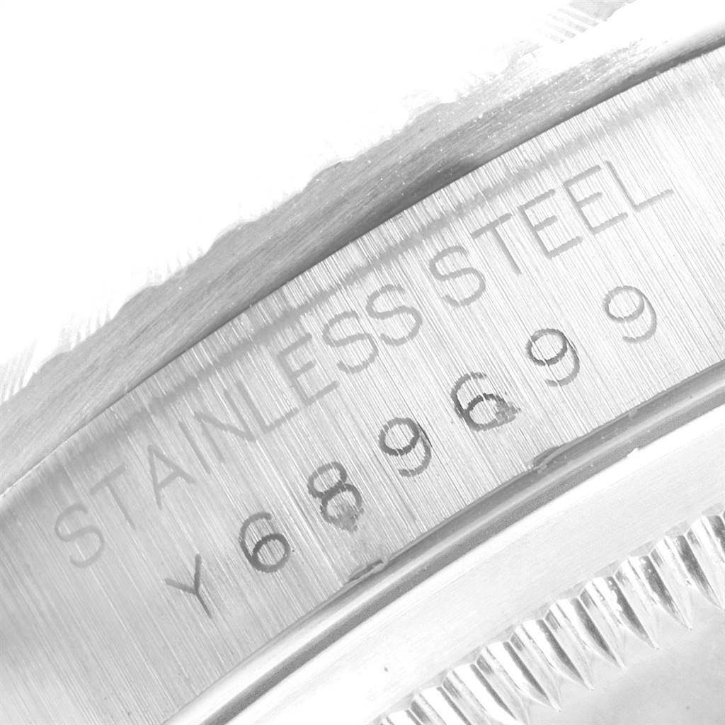 This close-up image shows the serial number engraved on the stainless steel case of a Rolex Datejust 16220 Men's Stainless Steel Silver Dial 16220 Men's Stainless Steel Silver Dial watch.