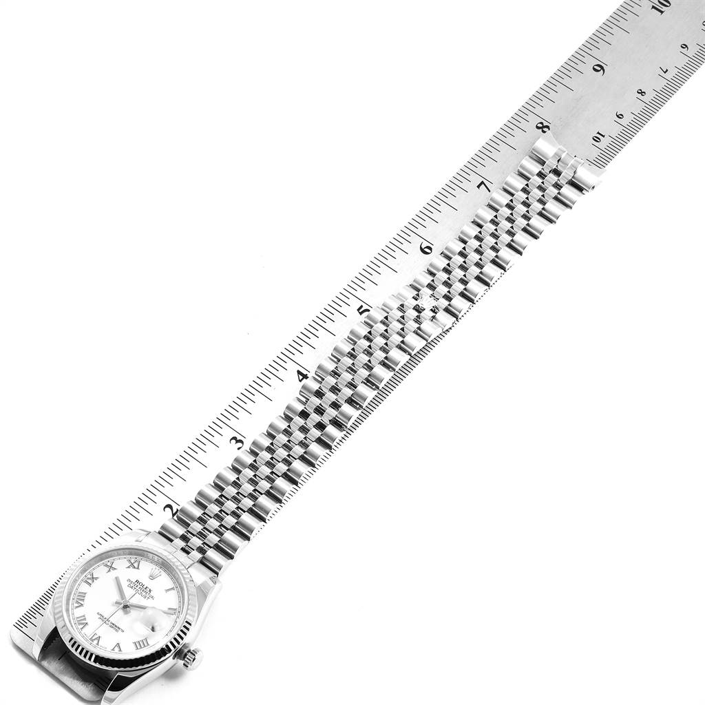 This top-down image shows the Rolex Datejust 116234 Men's Stainless Steel White Dial 116234 Men's Stainless Steel White Dial watch, focusing on the face and entire bracelet, along with a ruler for scale.