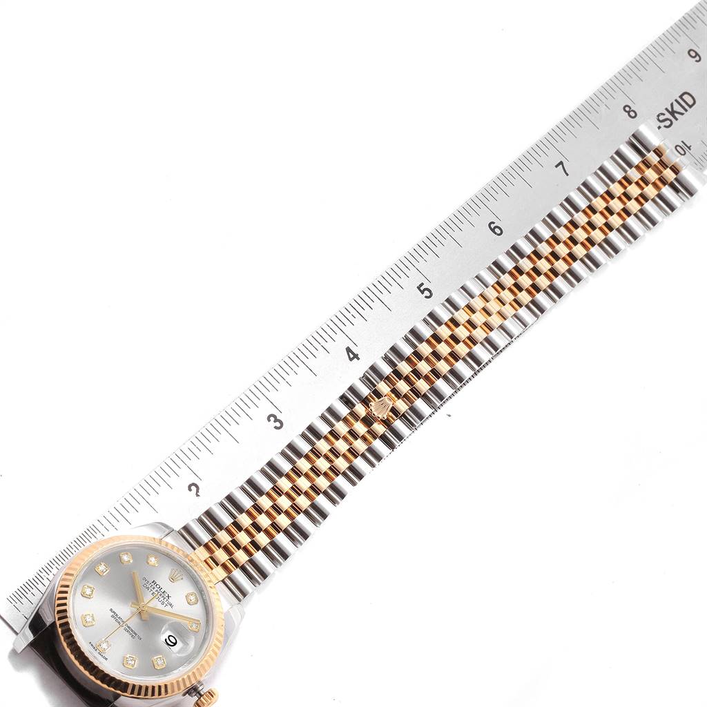 The image shows the face and bracelet of a Rolex Datejust 116233 Men's Steel and Gold (two tone) Silver Dial 116233 Men's Steel and Gold (two tone) Silver Dial watch, measured against a ruler.
