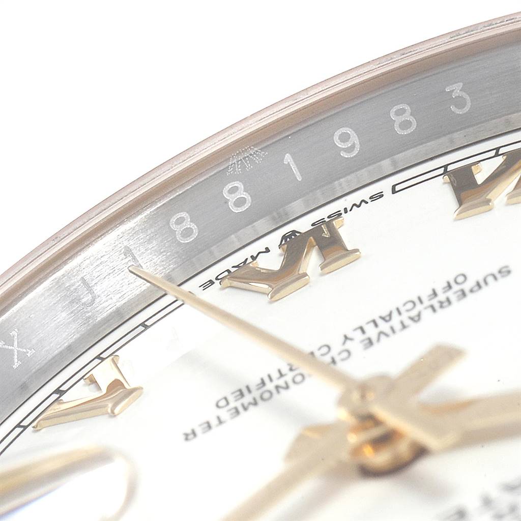 This image shows a close-up angle of the Rolex Datejust 126233 Men
s Steel and Gold (two tone) White Dial 126233 Men
s Steel and Gold (two tone) White Dial watch, featuring its hands, Roman numerals, and part of the rehaut.