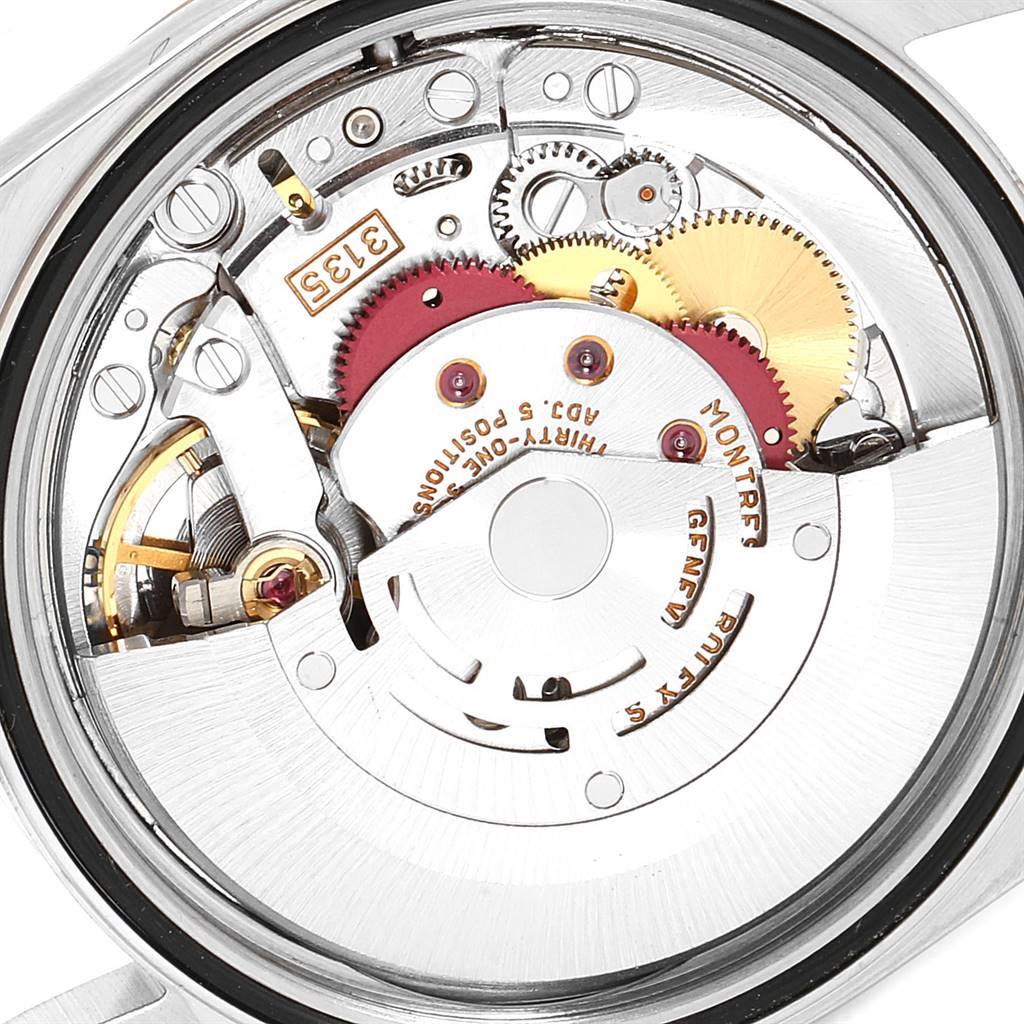 The image shows the internal mechanism of a Rolex Datejust 16233 Men's Steel and Gold (two tone) Blue Dial 16233 Men's Steel and Gold (two tone) Blue Dial watch, highlighting its gears and movement components.