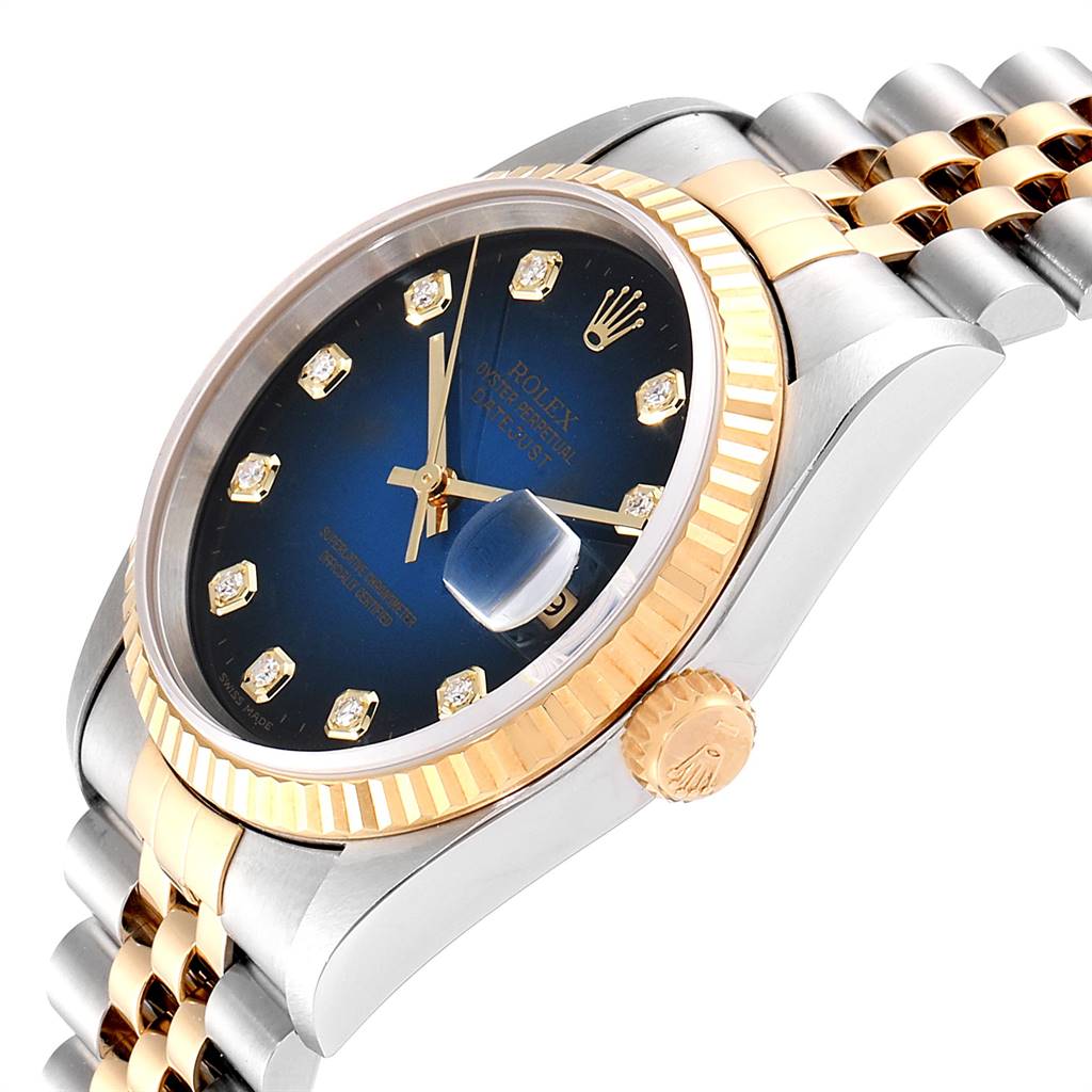 This image shows a Rolex Datejust 16233 Men's Steel and Gold (two tone) Blue Dial 16233 Men's Steel and Gold (two tone) Blue Dial watch at an angle, highlighting the dial, bracelet, crown, and fluted bezel.