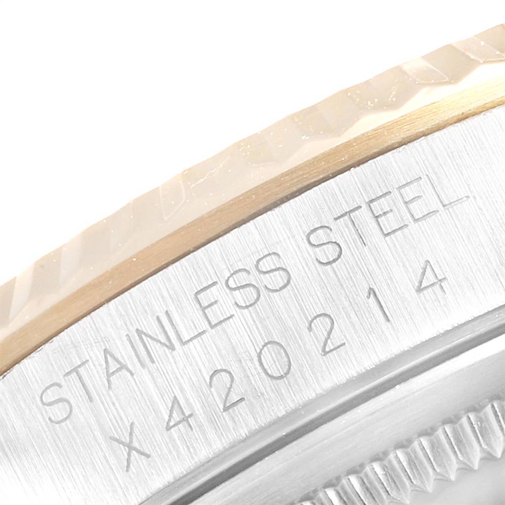 This image shows a close-up angle of the case edge and bezel of the Rolex Datejust 16233 Men's Steel and Gold (two tone) Champagne Dial 16233 Men's Steel and Gold (two tone) Champagne Dial model, highlighting the "Stainless Steel" engraving.