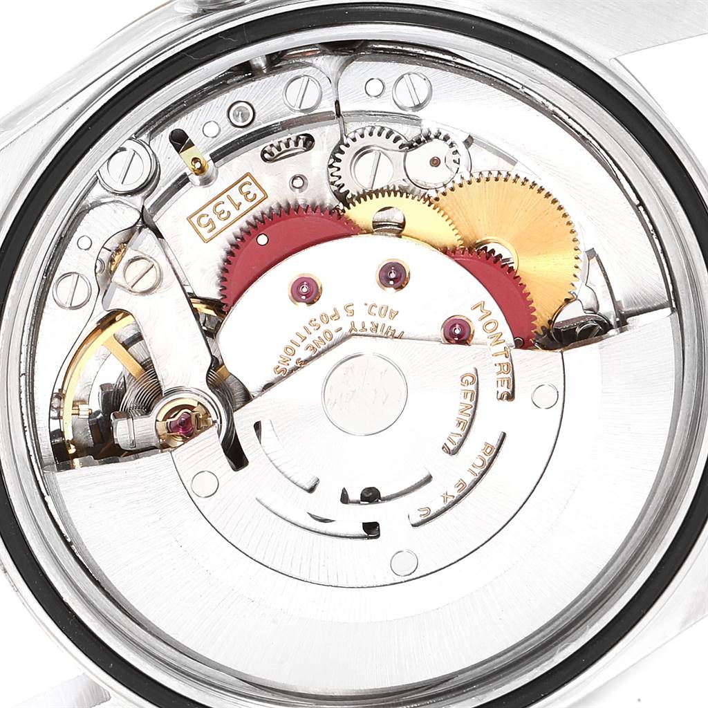 The image shows a close-up of the internal movement parts of a Rolex Datejust 16233 Men's Steel and Gold (two tone) Champagne Dial 16233 Men's Steel and Gold (two tone) Champagne Dial watch, focusing on its intricate gears and mechanisms.