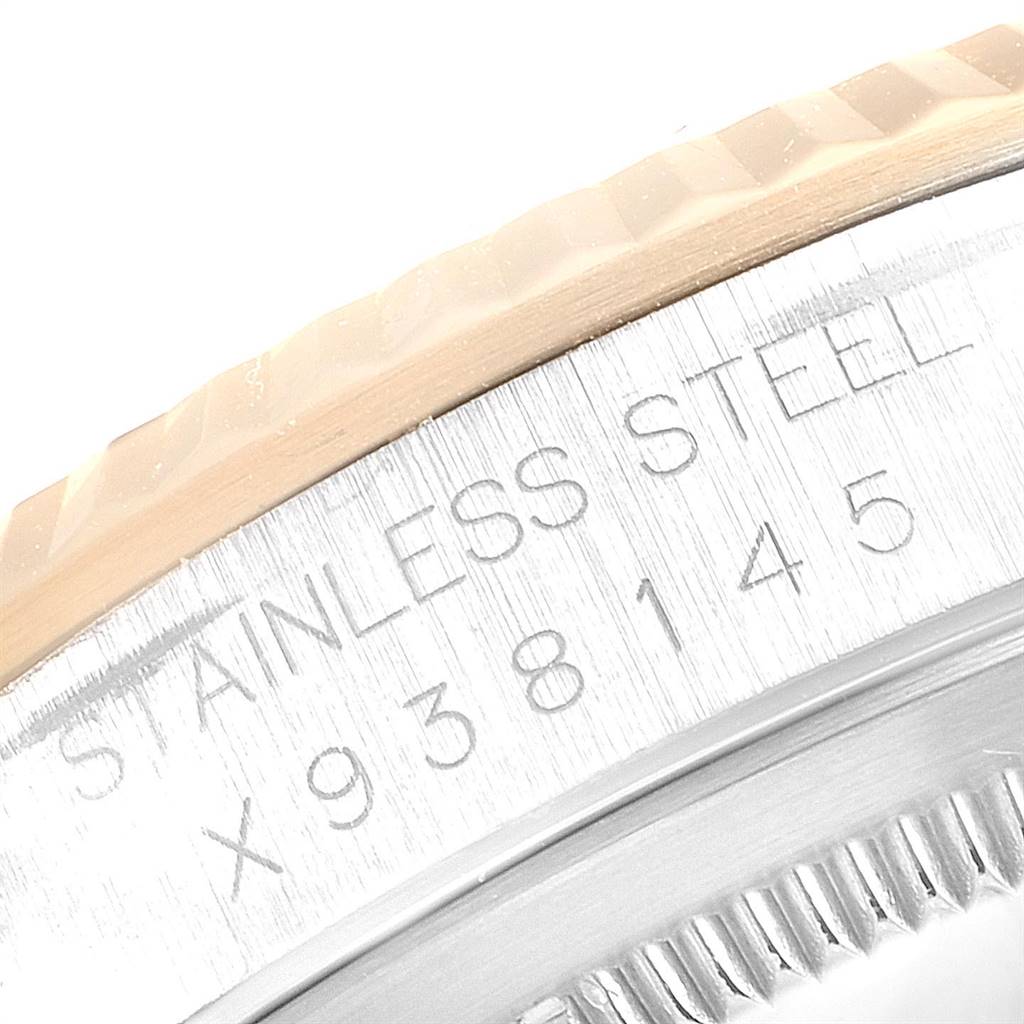 This close-up image shows part of the bezel and case of a Rolex Datejust 16233 Men's Steel and Gold (two tone) Grey Dial 16233 Men's Steel and Gold (two tone) Grey Dial watch, including the engraved serial number and "STAINLESS STEEL" text.