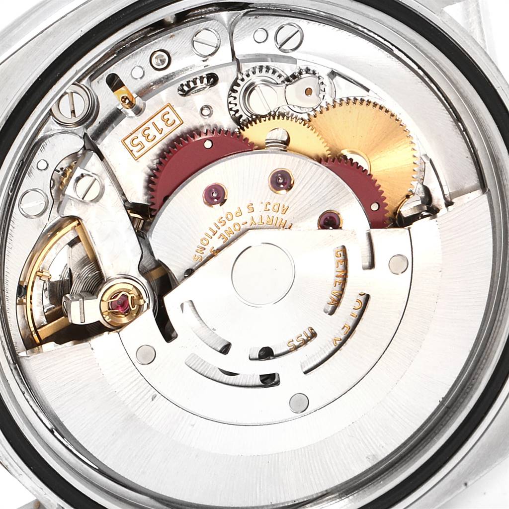 The image shows a close-up of the internal movement of a Rolex Datejust 116233 Men's Stainless Steel White Dial 116233 Men's Stainless Steel White Dial watch, highlighting gears and mechanical components.