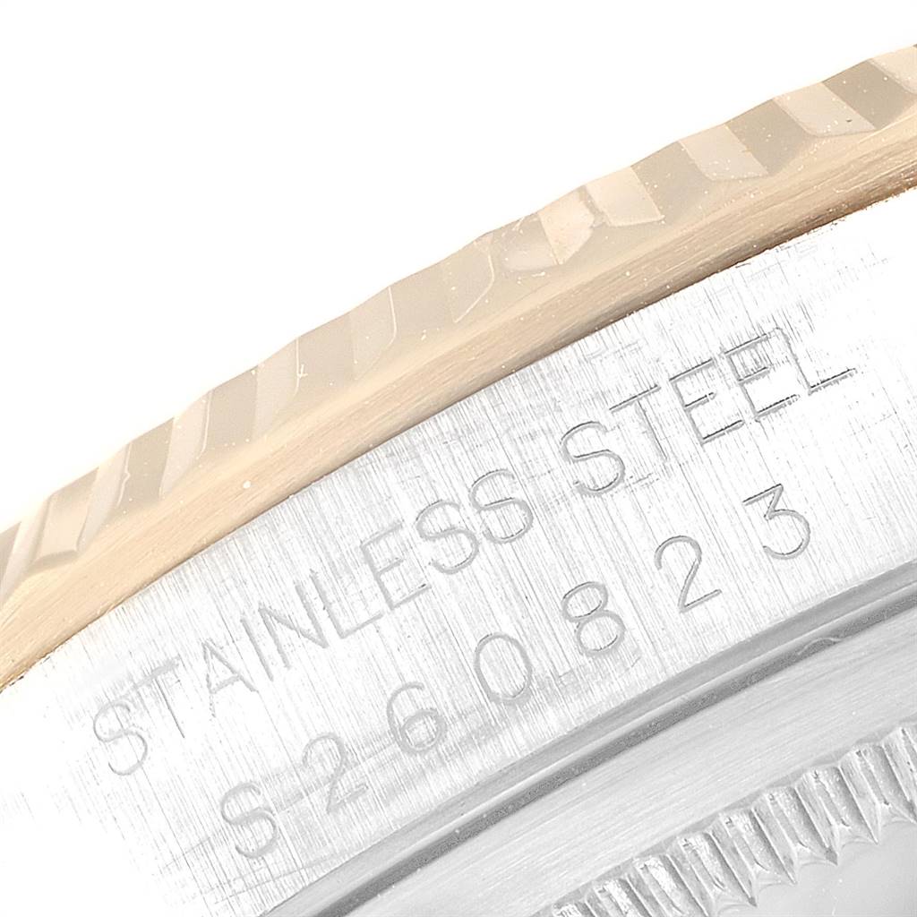 This close-up shot of the Rolex Datejust 16233 Men
s Steel and Gold (two tone) Champagne Dial 16233 Men
s Steel and Gold (two tone) Champagne Dial shows the fluted bezel and part of the inscription on the stainless steel case.