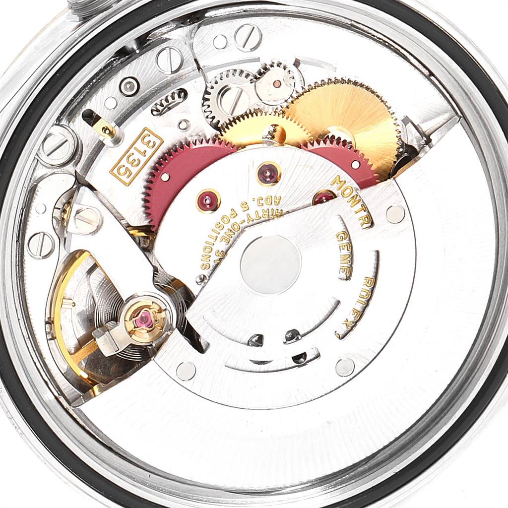 This image shows a close-up of the Rolex Datejust 16233 Men
s Steel and Gold (two tone) Champagne Dial 16233 Men
s Steel and Gold (two tone) Champagne Dial movement mechanism with gears and rotor visible.