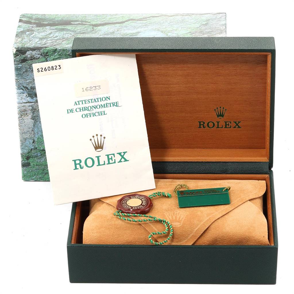 The image shows an open Rolex watch box with a certificate, tags, and cloth for a Datejust model.