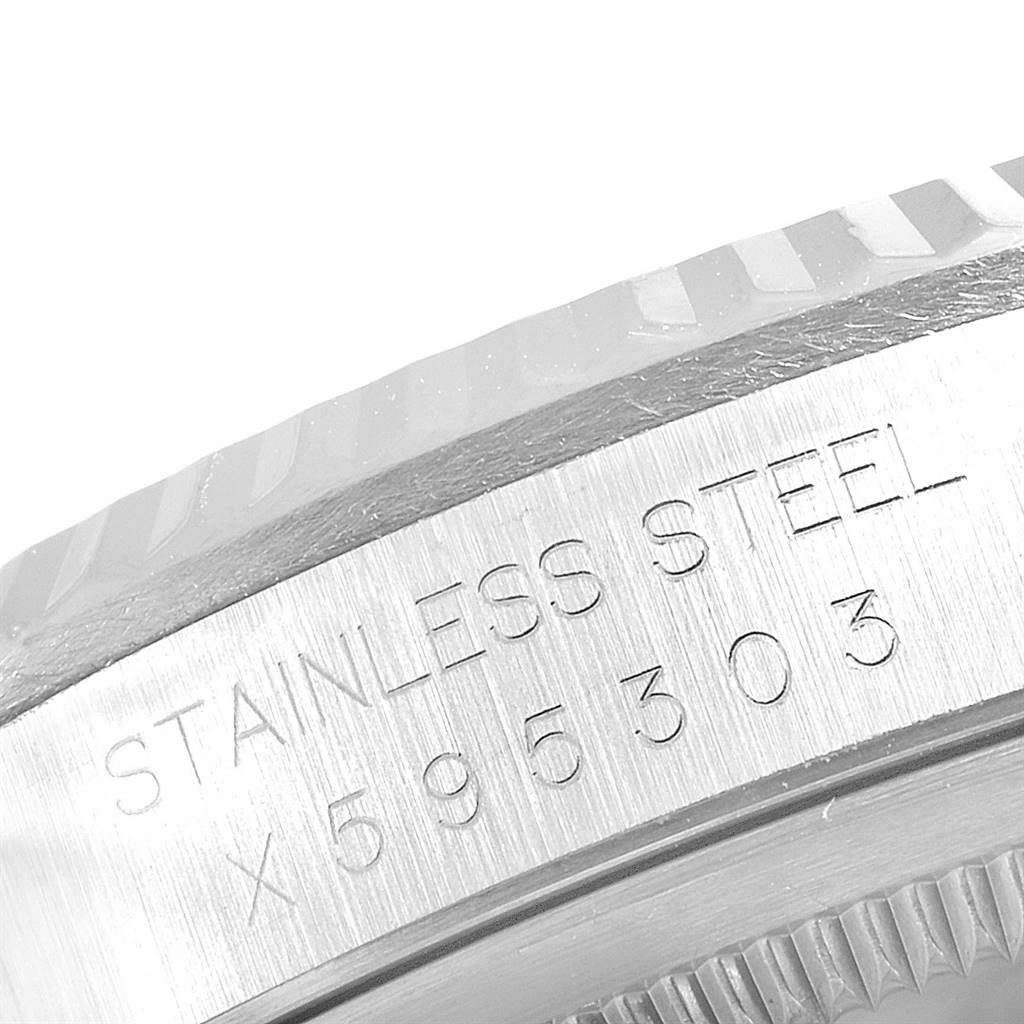 The image shows a close-up of the bezel and case back of a Rolex Datejust 16234 Men's Stainless Steel White Dial 16234 Men's Stainless Steel White Dial, featuring part of its serial number and "Stainless Steel" engraving.