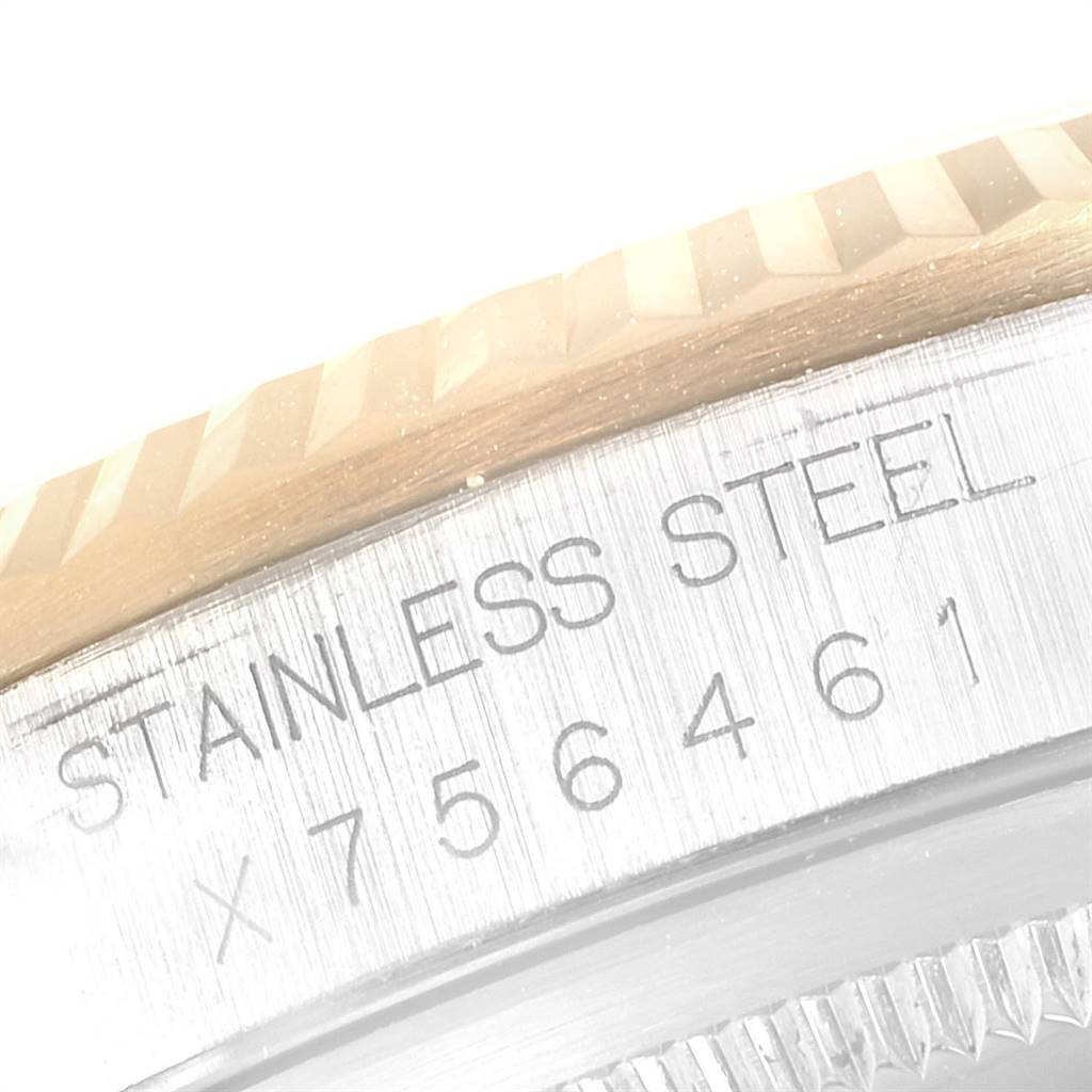 This image shows a close-up angle of the engraved serial number and "Stainless Steel" text on a Rolex Datejust 16233 Men
s Steel and Gold (two tone) Champagne Dial 16233 Men
s Steel and Gold (two tone) Champagne Dial watch.