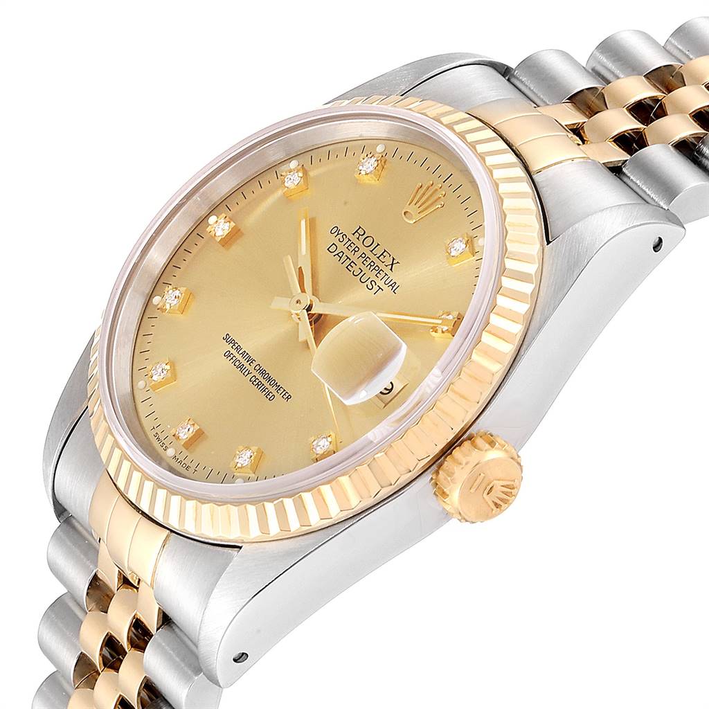 This image shows a close-up of a Rolex Datejust 16233 Men
s Steel and Gold (two tone) Champagne Dial 16233 Men
s Steel and Gold (two tone) Champagne Dial watch, highlighting the golden dial, bezel, crown, and two-tone bracelet.