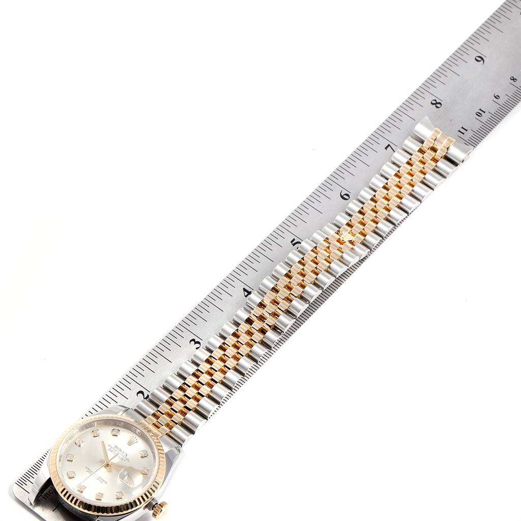 This image shows a top-down view of a Rolex Datejust 116233 Men
s Stainless Steel Silver Dial 116233 Men
s Stainless Steel Silver Dial watch with a ruler measuring its bracelet length.