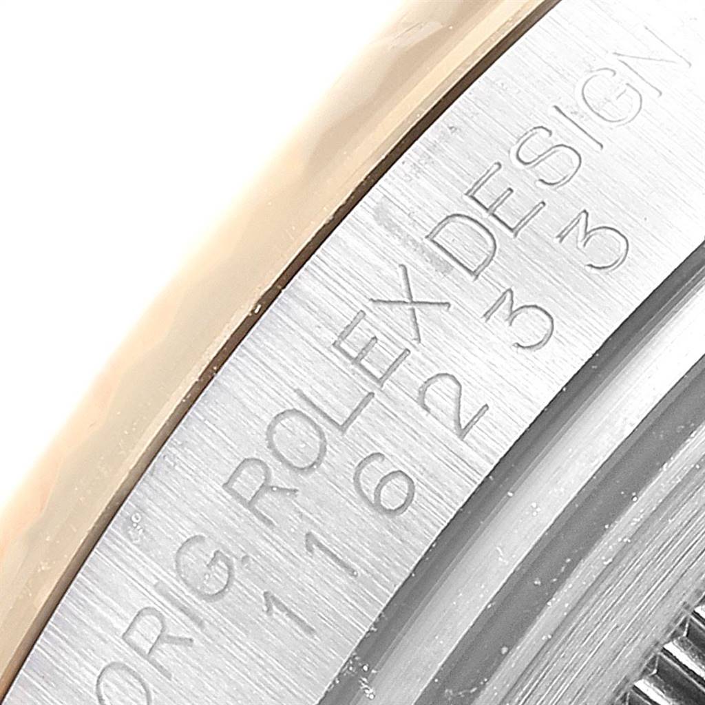 This close-up shows the engraved edge of the bezel on a Rolex Datejust 116233 Men
s Stainless Steel Silver Dial 116233 Men
s Stainless Steel Silver Dial watch.