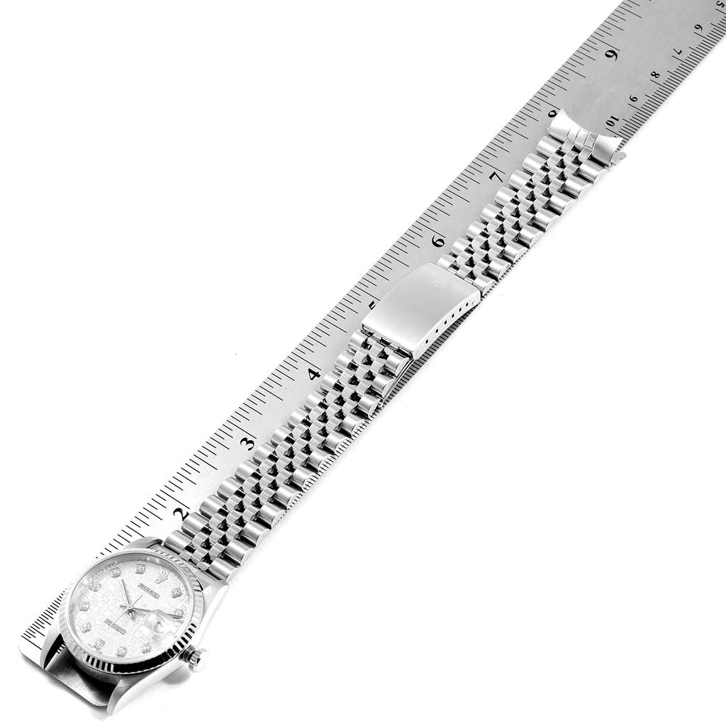 The Rolex Datejust 16234 Men's Stainless Steel Silver Dial 16234 Men's Stainless Steel Silver Dial watch is shown from a top-down angle, with the dial and entire bracelet visible against a ruler for size reference.