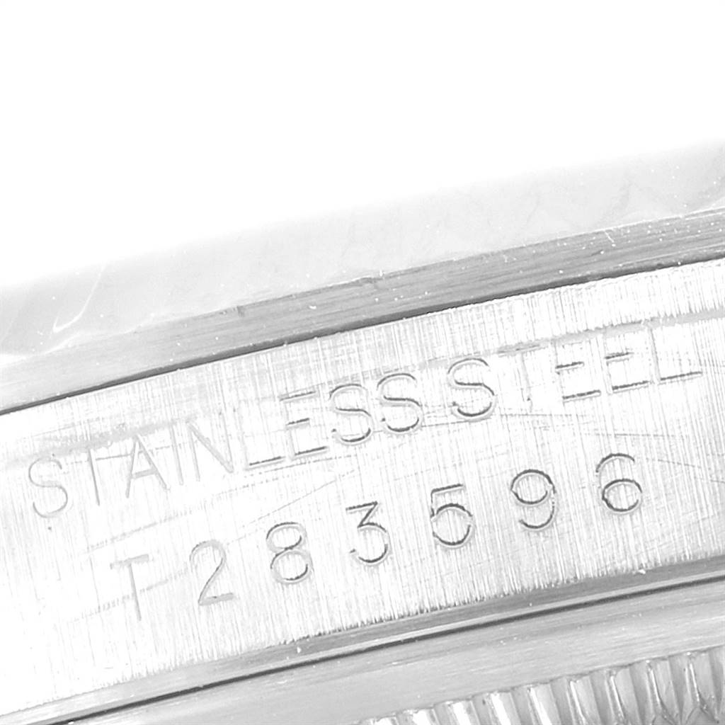 The image shows a close-up of the serial number and "STAINLESS STEEL" engraving on the case of a Rolex Datejust 16234 Men's Stainless Steel Silver Dial 16234 Men's Stainless Steel Silver Dial watch.