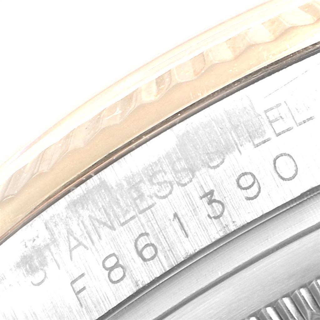 The image shows a close-up view of the fluted bezel and part of the engraved case of a Rolex Datejust 116233 Men
s Steel and Gold (two tone) Blue Dial 116233 Men
s Steel and Gold (two tone) Blue Dial watch.