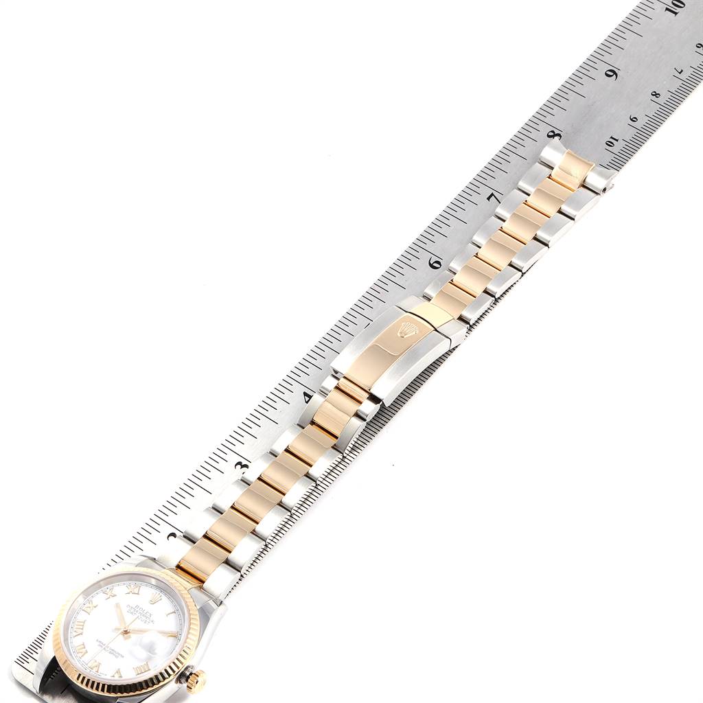 The image shows a side view of a Rolex Datejust 116233 Men's Stainless Steel White Dial 116233 Men's Stainless Steel White Dial watch, including the face, bracelet, and clasp, alongside a measuring ruler.