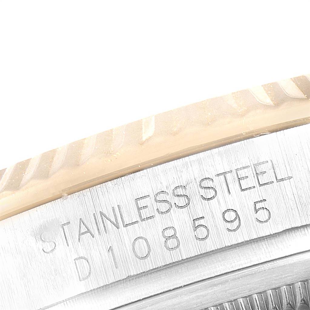 The image shows a close-up of the inscription on the side of the bezel of a Rolex Datejust 116233 Men's Stainless Steel White Dial 116233 Men's Stainless Steel White Dial watch, indicating "STAINLESS STEEL" with a serial number.